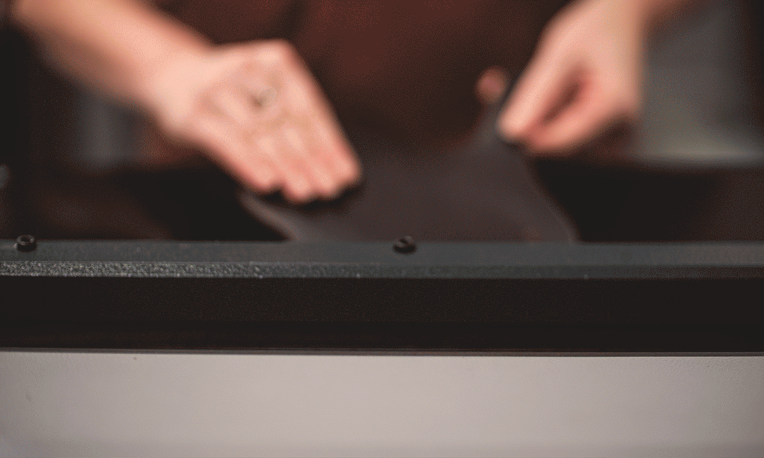 animation of using leather splitter with piece of leather coming forward