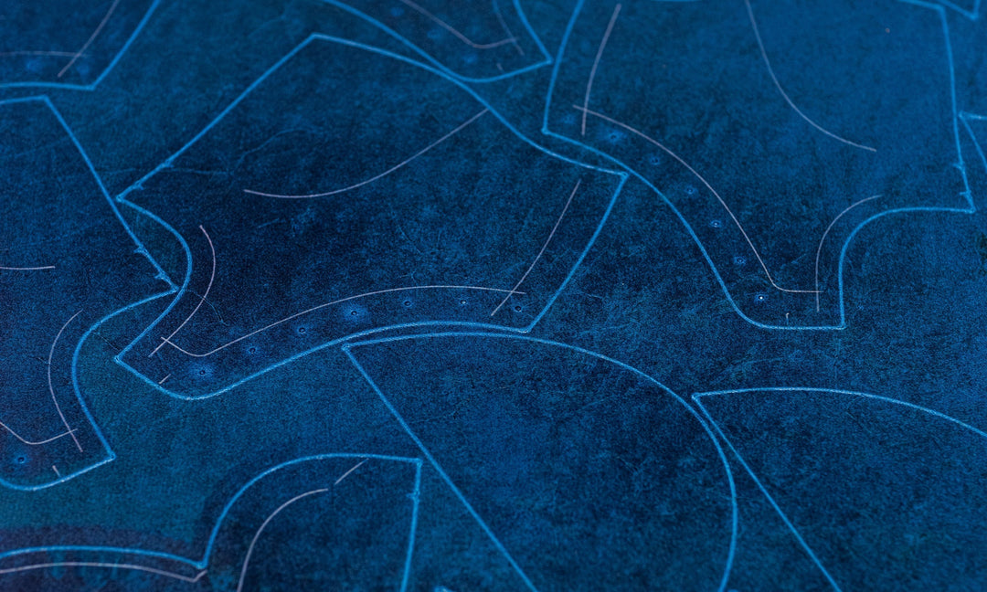 textured blue leather with light color outlines for pieces of boots on cutting machine