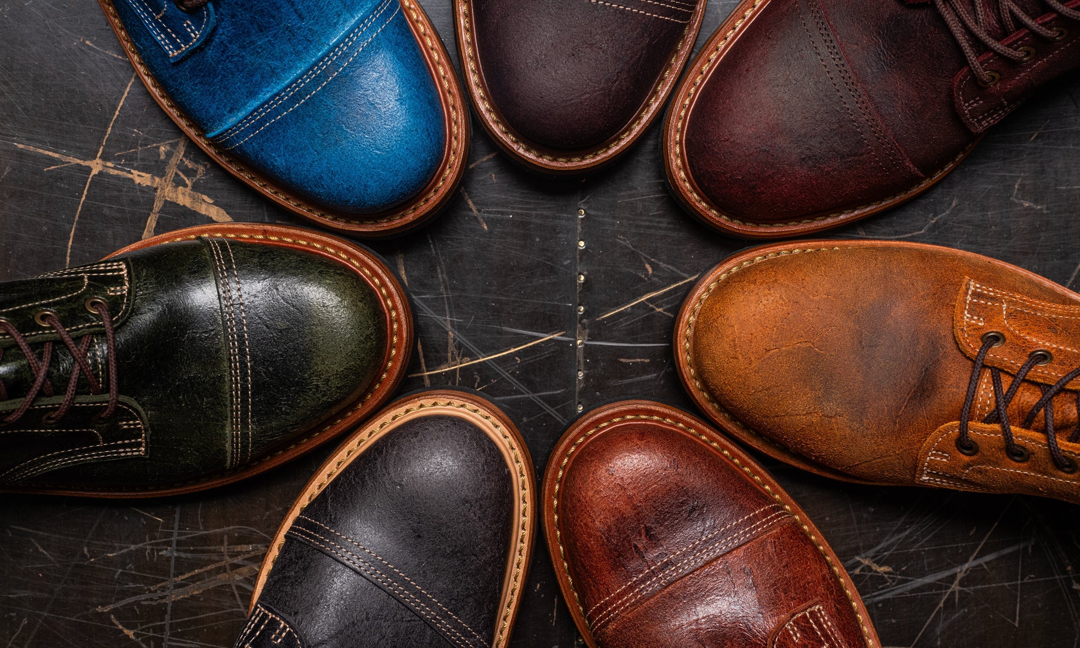 laydown of variety of boots with different colored leathers from c.f. stead tannery