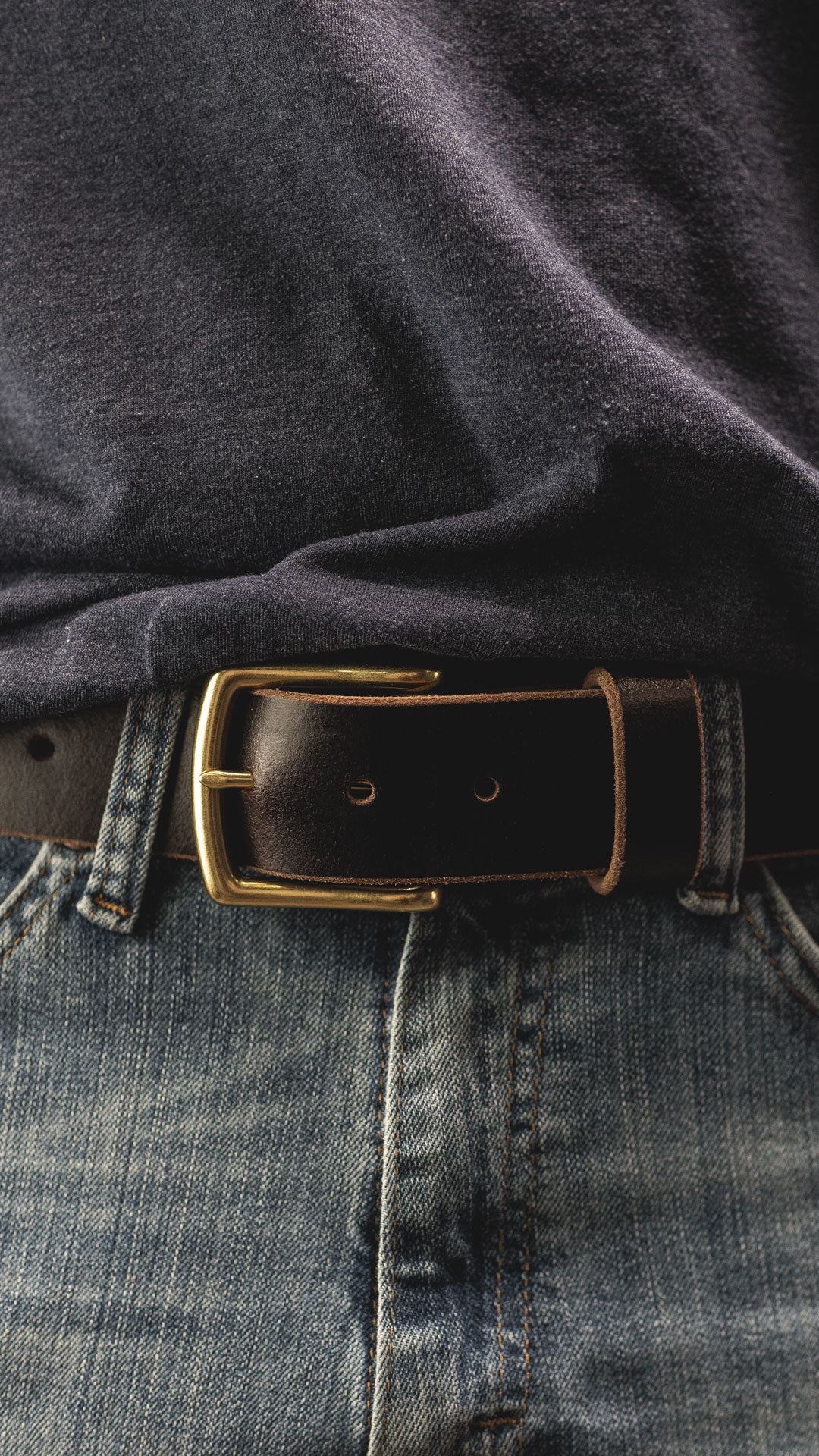 man wearing dark brown leather belt close shot wearing denim