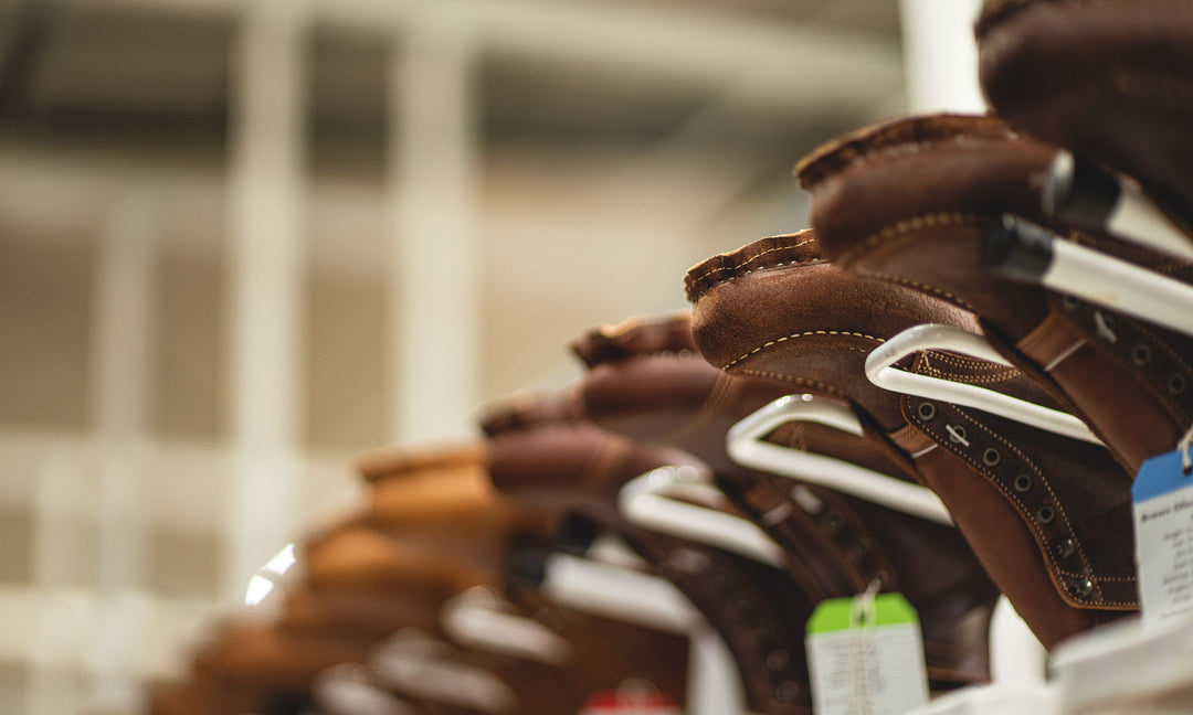 brown rough out boots upside down on racks in production in factory