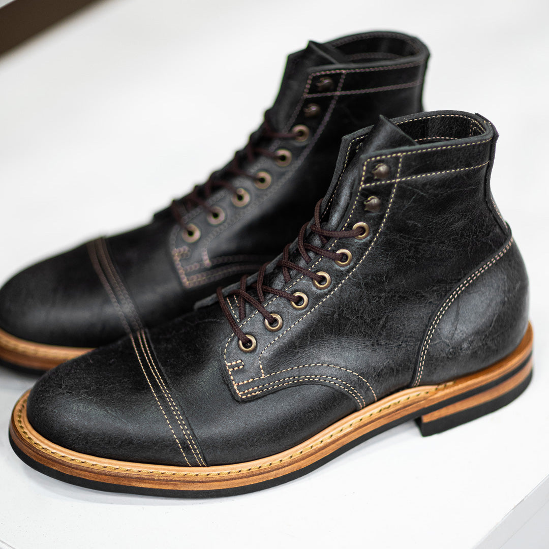 pair of gray textured leather boots with natural leather welt