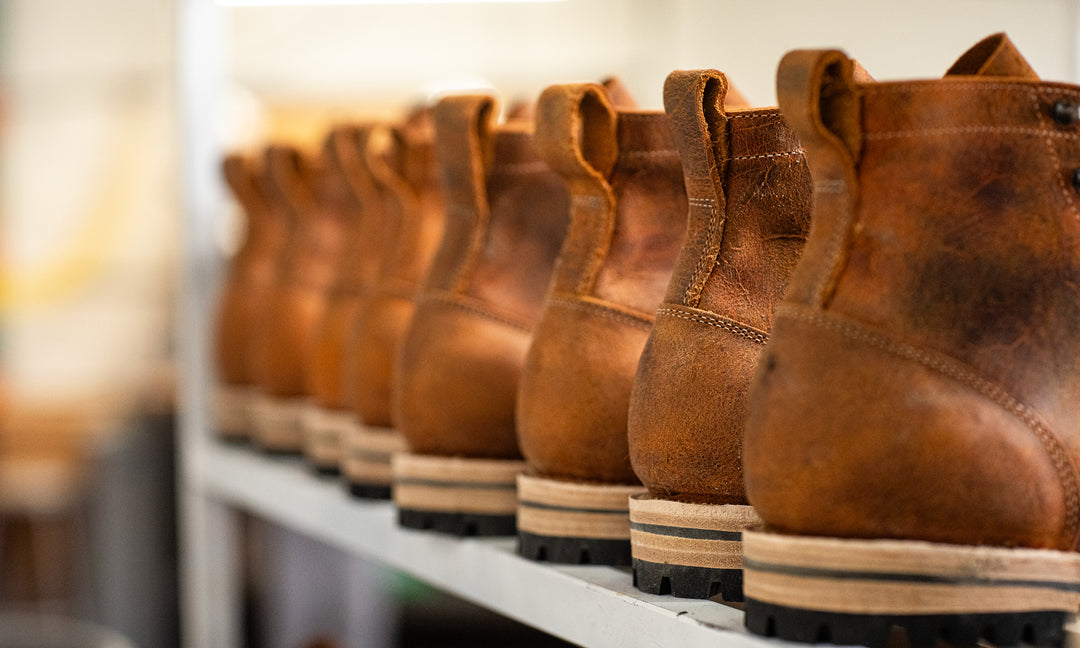 coach rambler boots on white rack waiting to be finished
