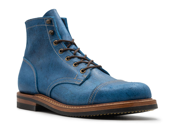 3qtr view of blue textured leather boot on white background