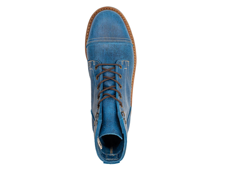 topdown view of blue textured leather boot on white background