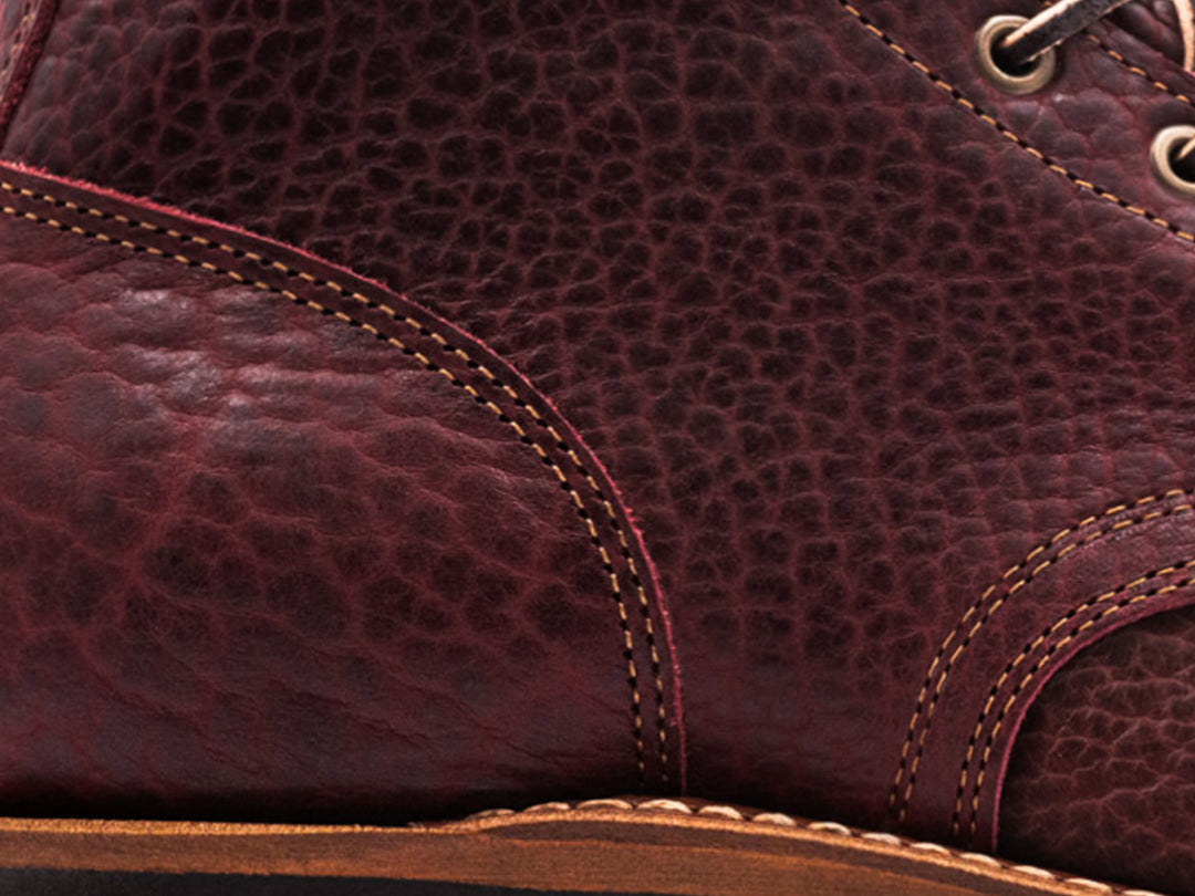 close up shot of black cherry shrunken bison leather
