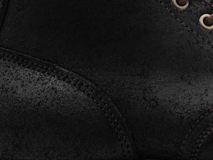 close up shot of black oiled rough out leather