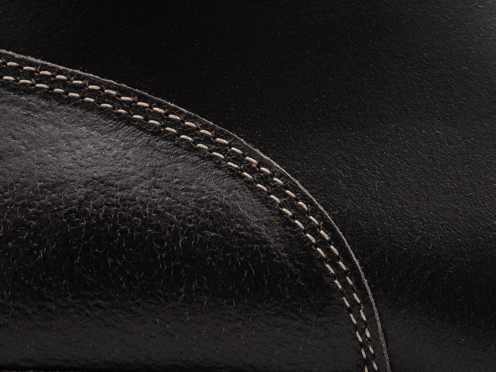 close up shot of black waxed flesh leather