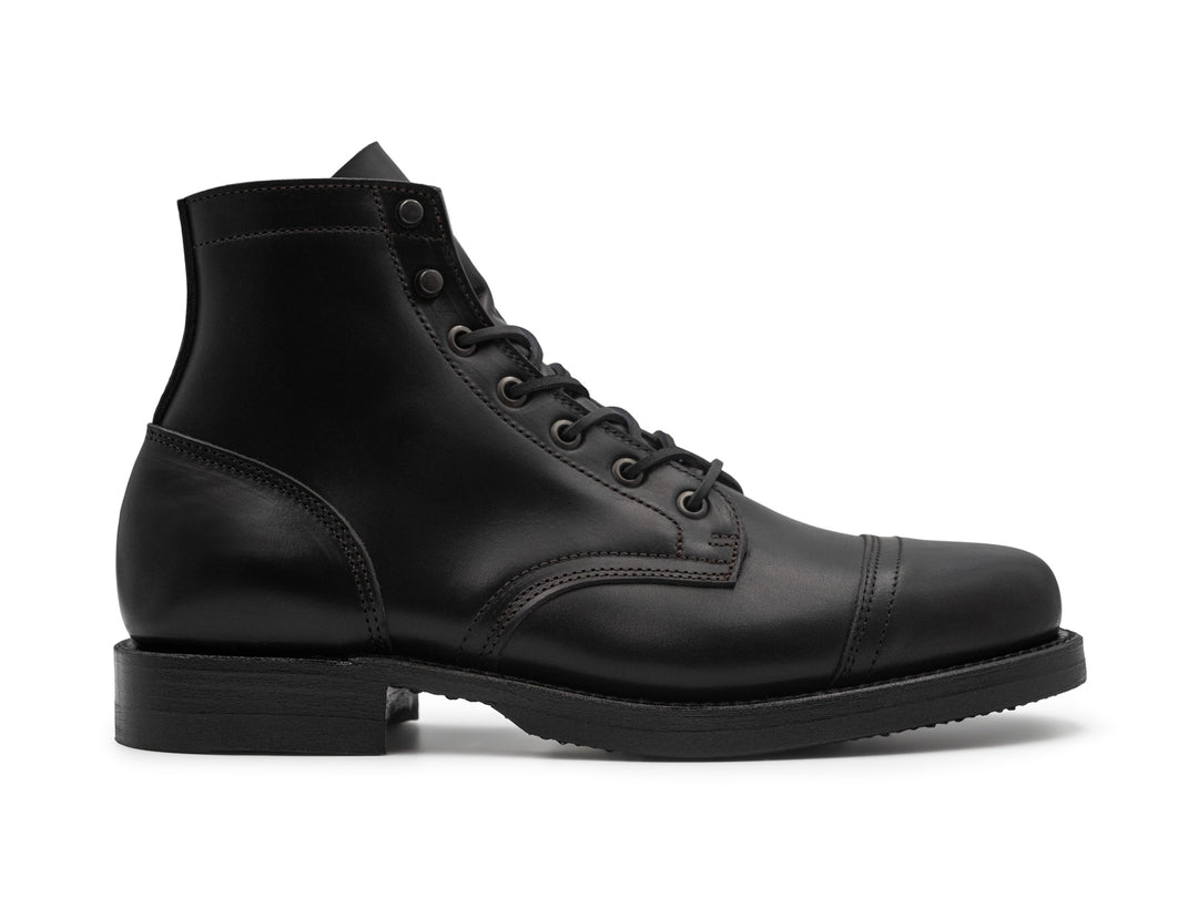 side view of black chromexcel leather boot on white background