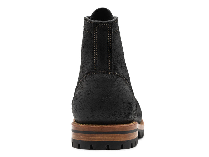back view of black moc toe boots on white background