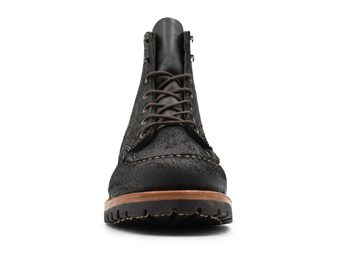 front view of black moc toe boots on white background