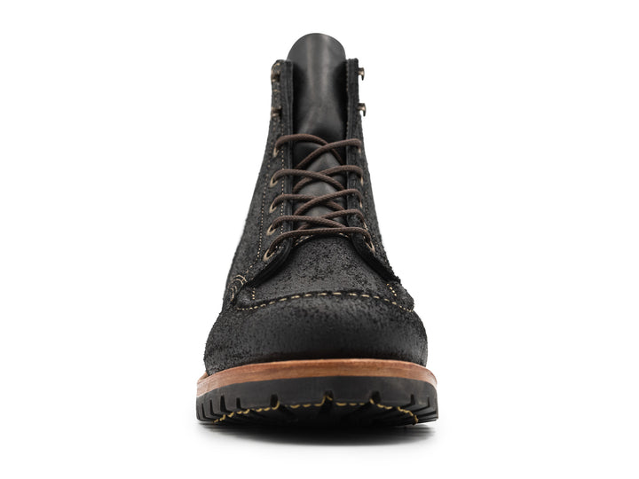 front view of black moc toe boots on white background