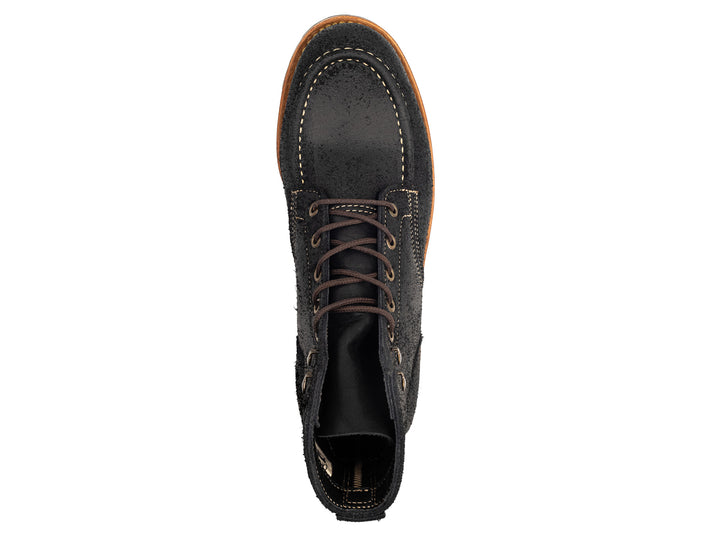 topdown view of black moc toe boots on white background