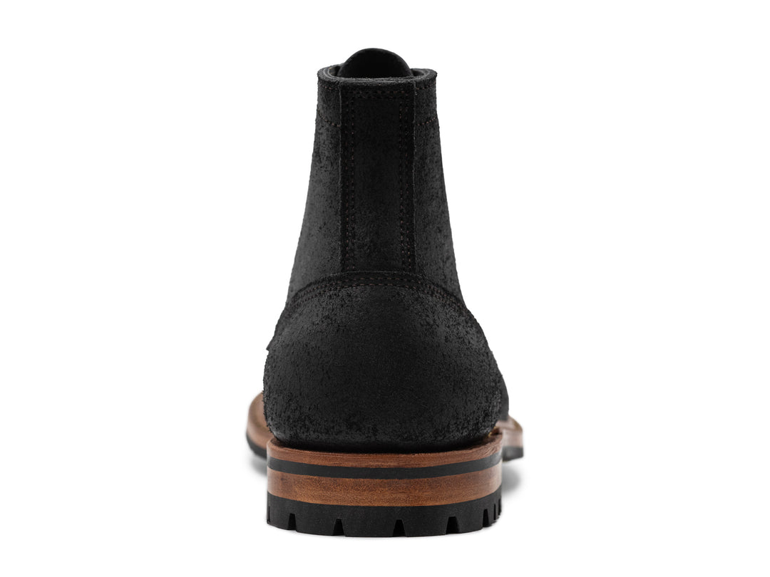 rear view of black rough out boot on white background