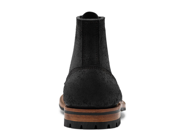 rear view of black rough out boot on white background