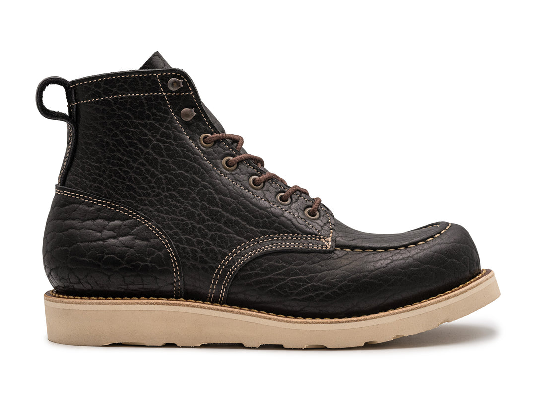 side view black shrunken bison boot on wedge sole on white background