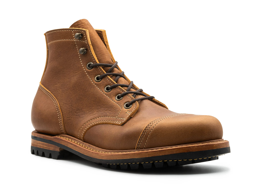3qtr view of tan brown leather cap toe boot on white background