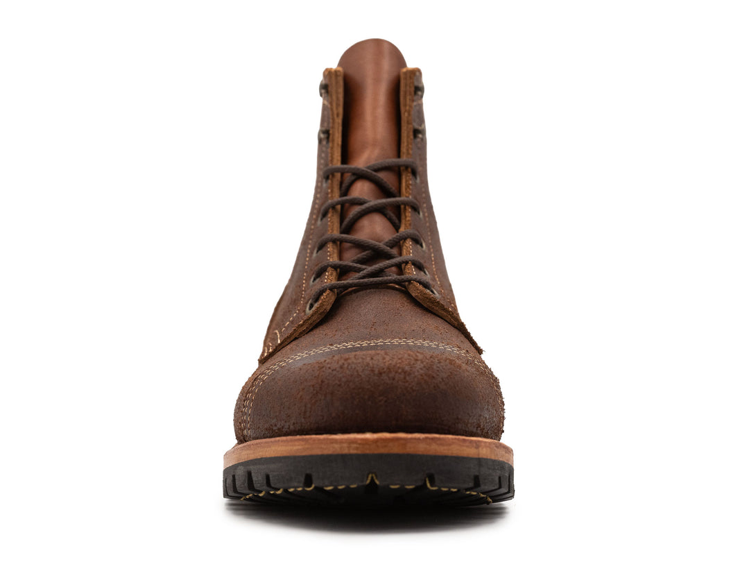 dark brown rough out leather boot front view on white background