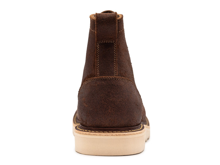 rear view of brown oiled rough out leather moc toe boot on white background