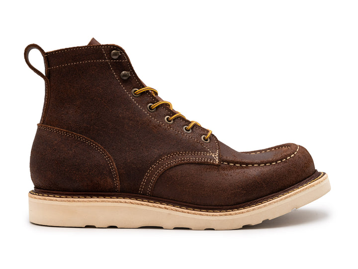 side view of brown oiled rough out leather moc toe boot on white background