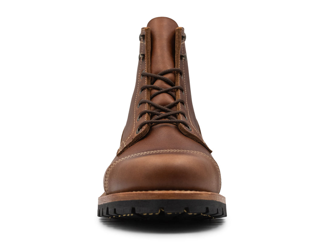 Brown leather boot on a white background front view