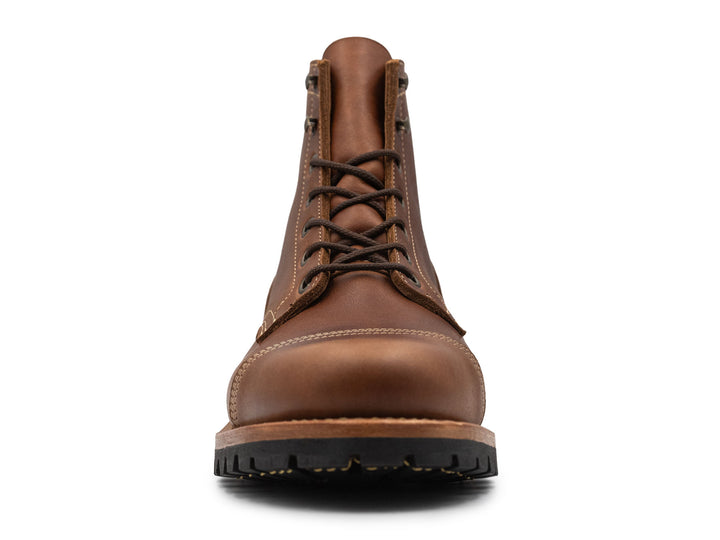 Brown leather boot on a white background front view