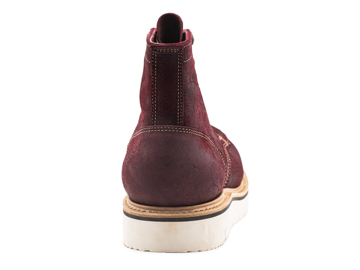 back view of burgundy rambler leather moc toe boot on white background