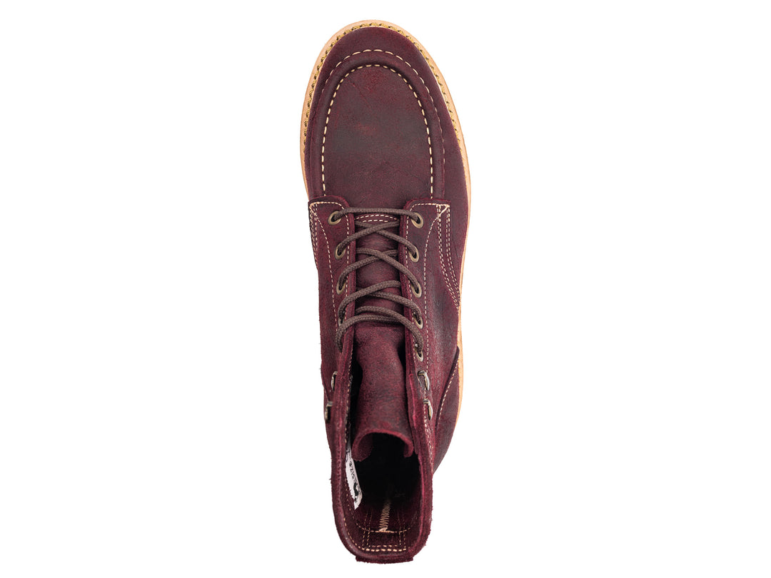 topdown view of burgundy rambler leather moc toe boot on white background