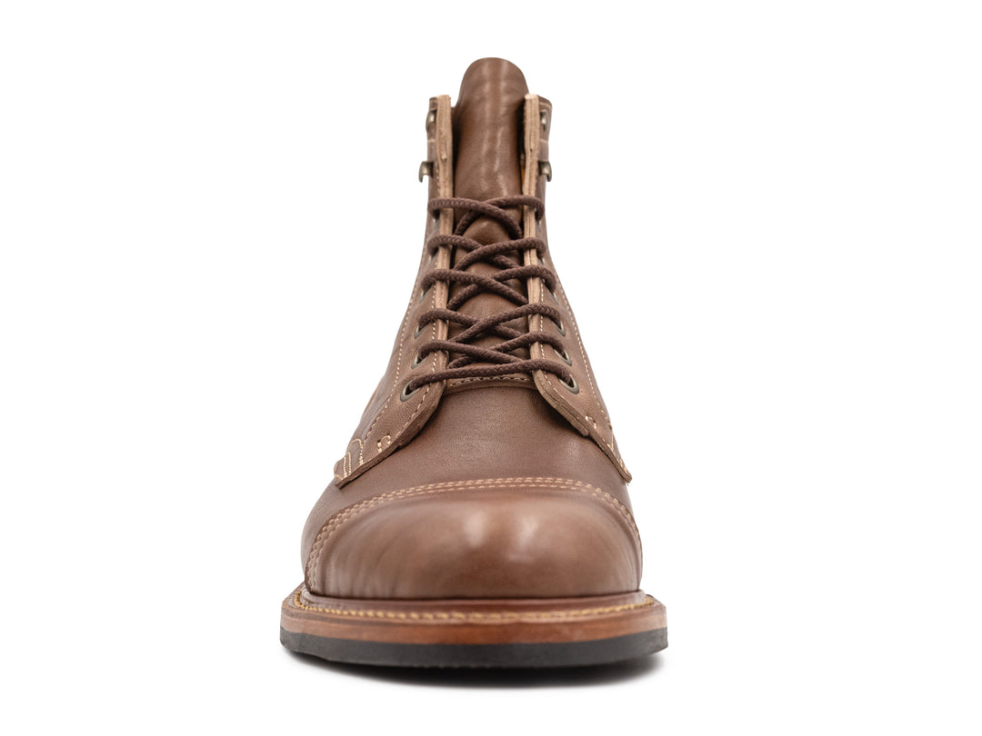front view of light brown leather boot on white background