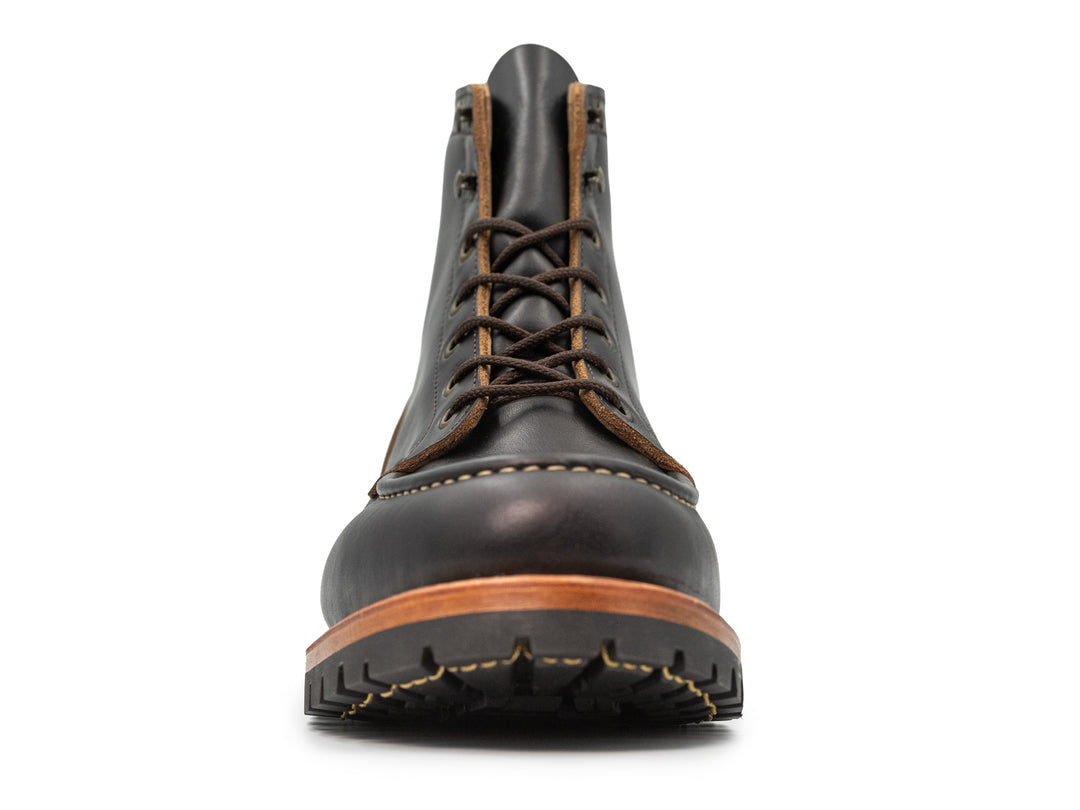 front view of black moc toe boot on white background