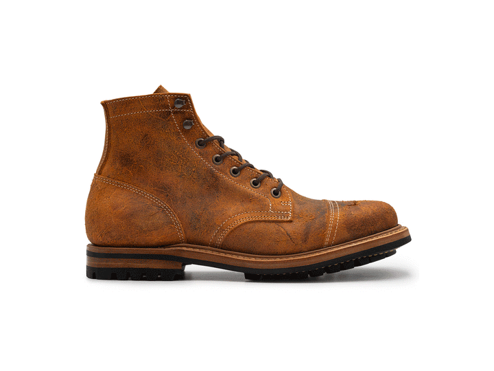 animated rotating view of single textured orange leather boot with black outsole on white background