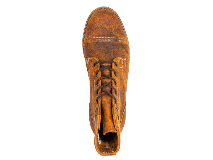 topdown view of single textured orange leather boot with black outsole on white background