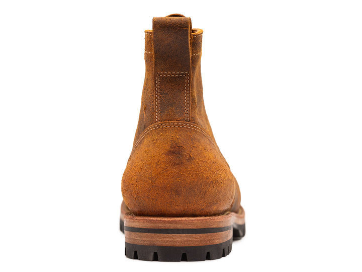orange textured leather boot from back on white background
