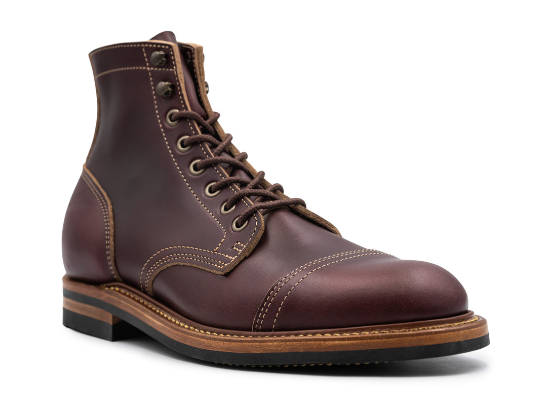 three-quarter view of dark burgundy leather boot on white background