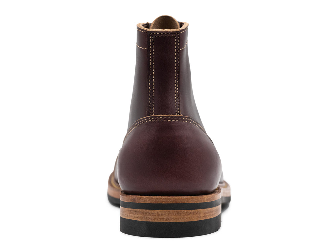 rear view of dark burgundy leather boot on white background