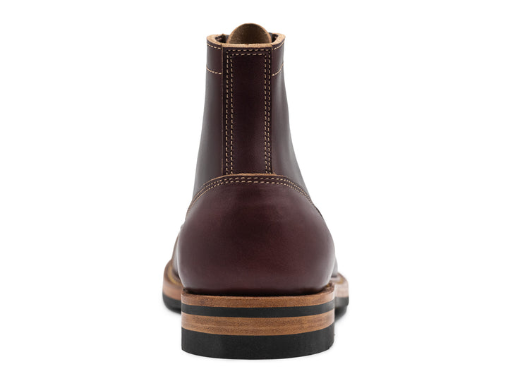 rear view of dark burgundy leather boot on white background