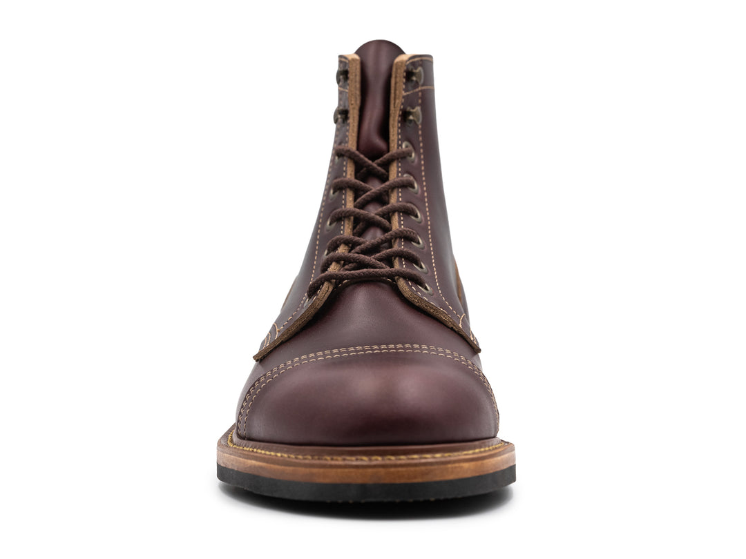 front view of dark burgundy leather boot on white background