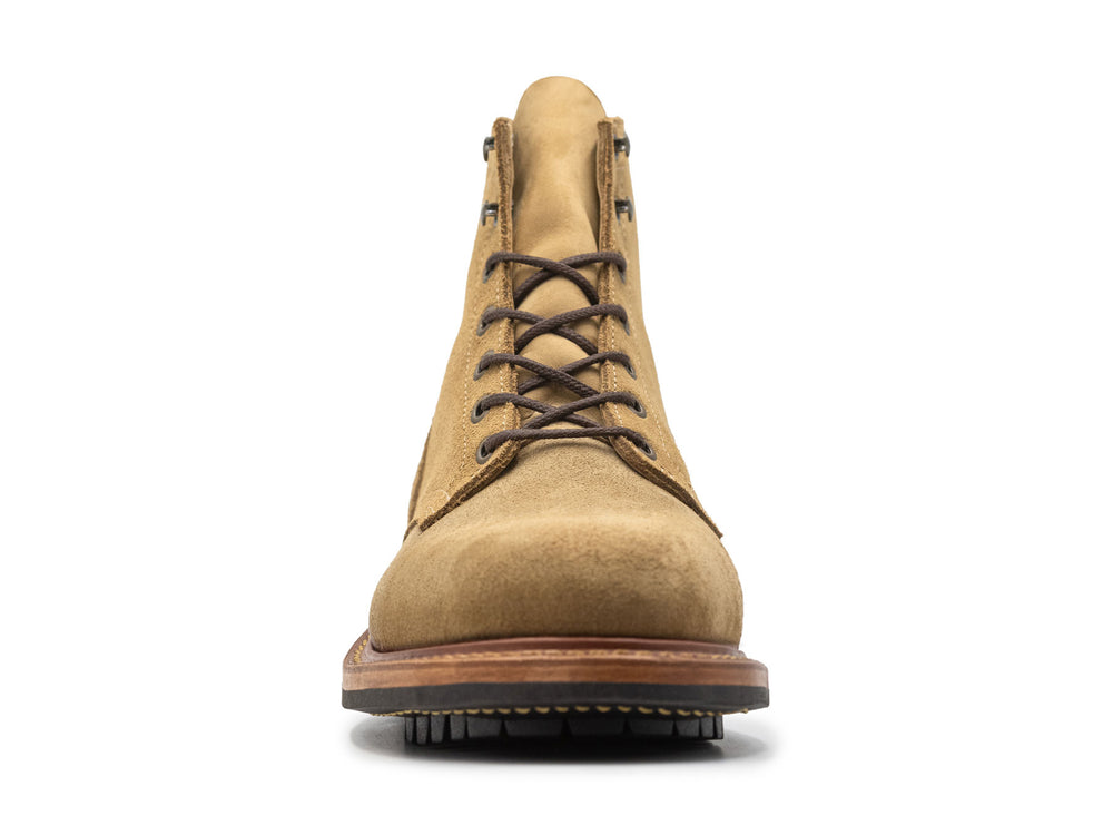 front view of tan leather boot on white background