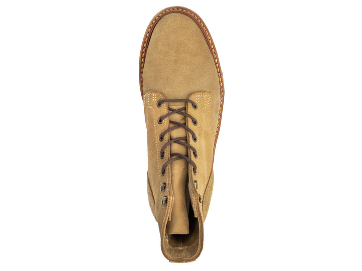 top-down view of tan leather boot on white background