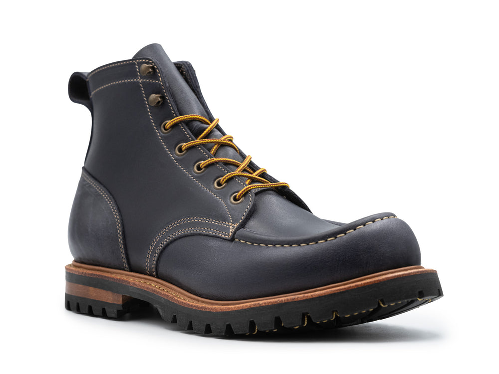 three-quarter view of steel blue leather boot on white background