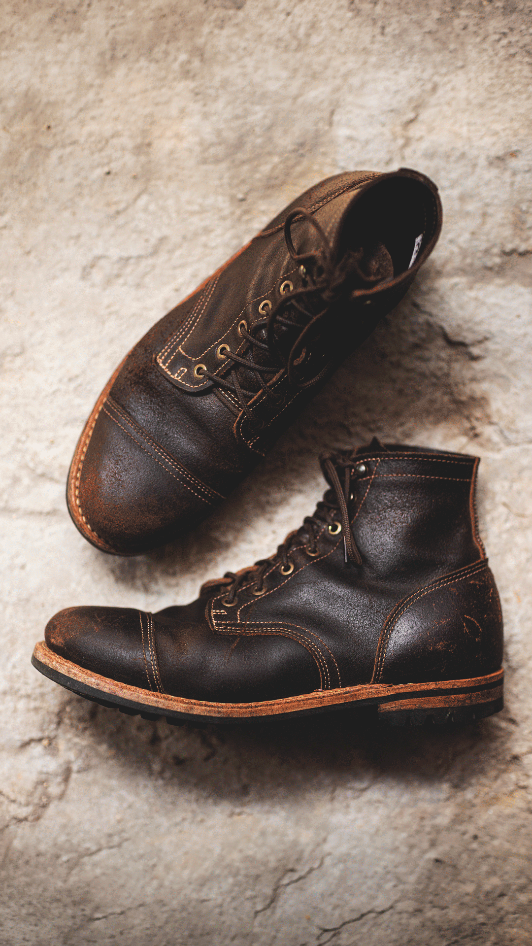 image of java waxed flesh boots laying on hard light colored ground with slight 3d effect shifting perspective