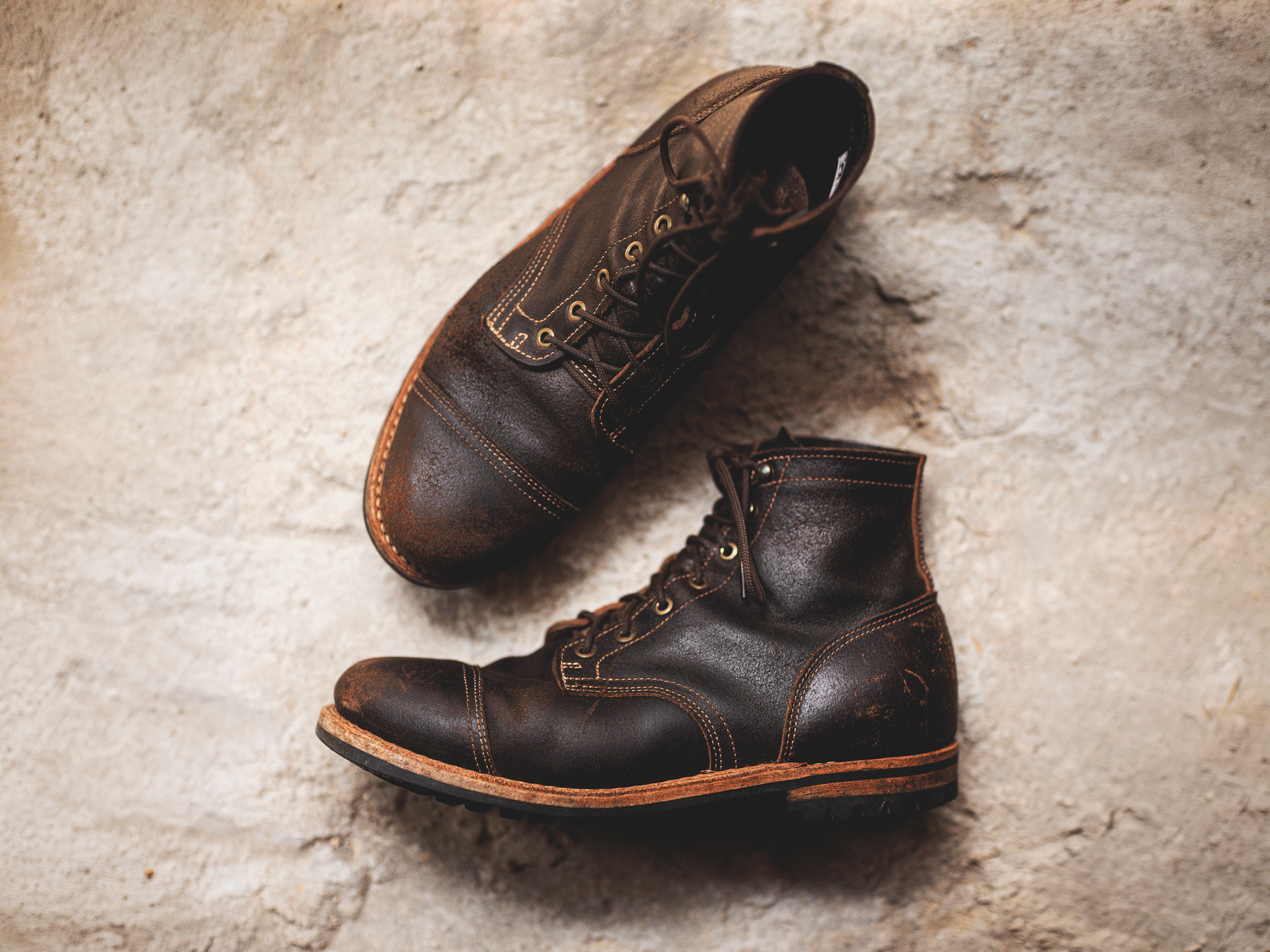 image of java waxed flesh boots laying on hard light colored ground with slight 3d effect shifting perspective