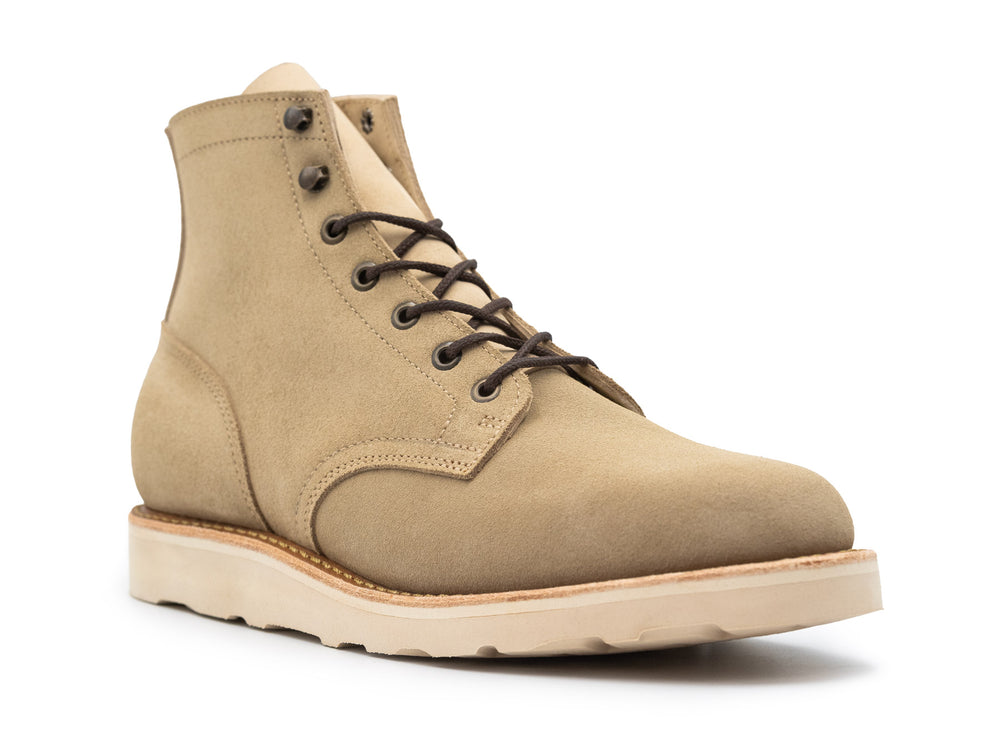 Tan boot with a white sole on a white background 3QTR view