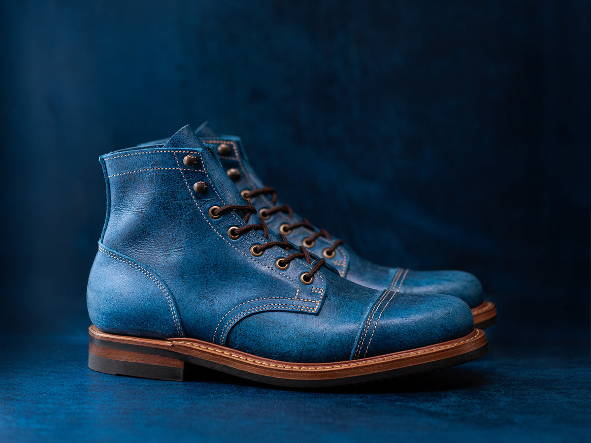 blue leather boots on blue leather background