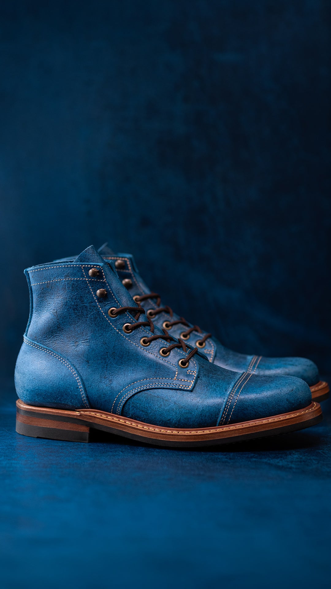 blue leather boots on blue leather background
