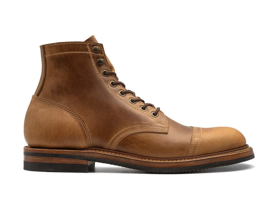 side view of sesame double shot leather boot on white background