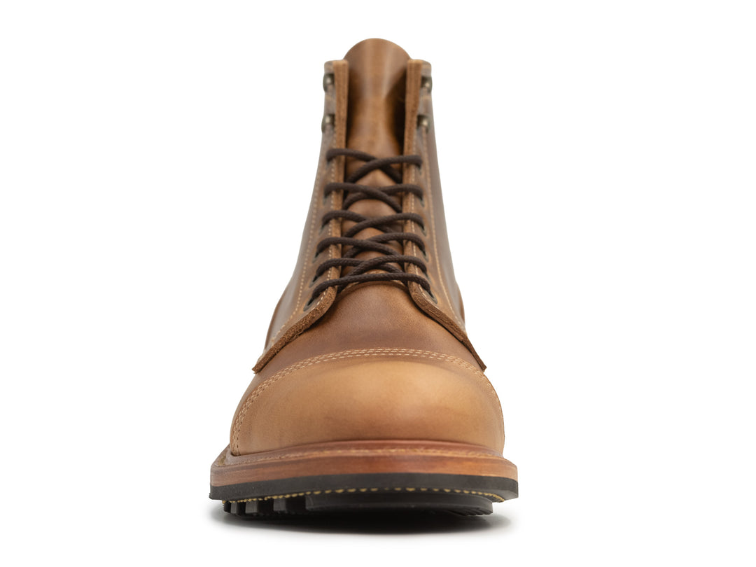 front view of tan caramel leather boot on white background