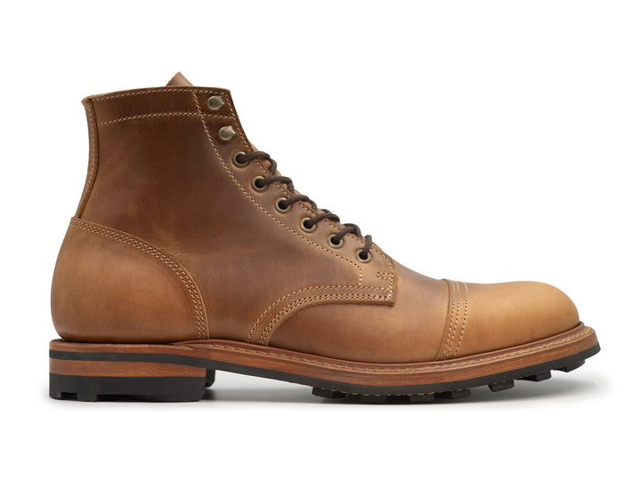 A single tan brown leather lace-up ankle boot with a cap toe and stacked sole, shown in profile against a plain white background