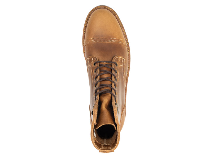 topdown view of tan caramel leather boot on white background
