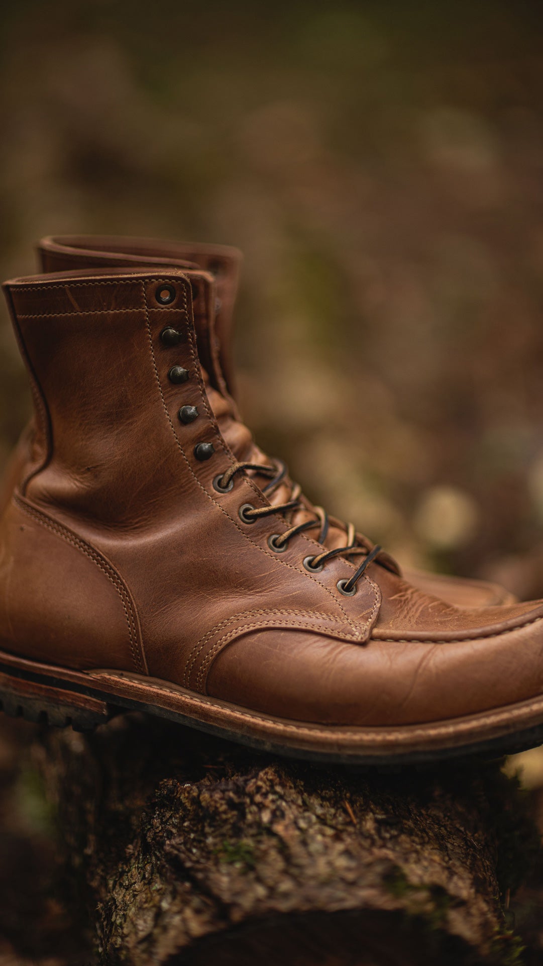 sesame double shot upland moc toe boot with out of focus foliage in background